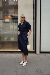 a lady wears a midi denim skirt with a matching denim shirt